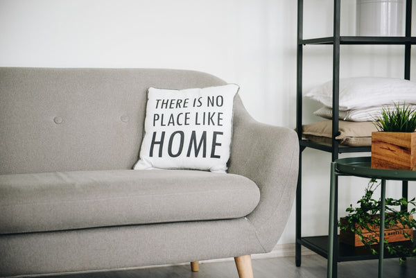 White throw pillow on a gray sofa
