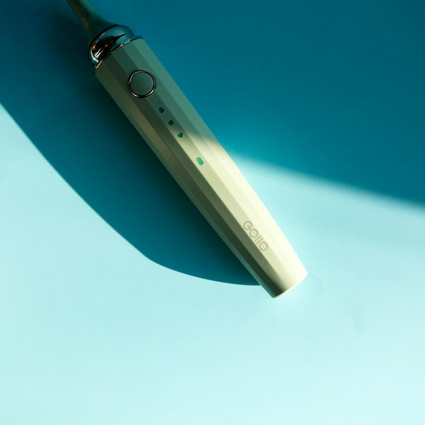 White and blue electric toothbrush