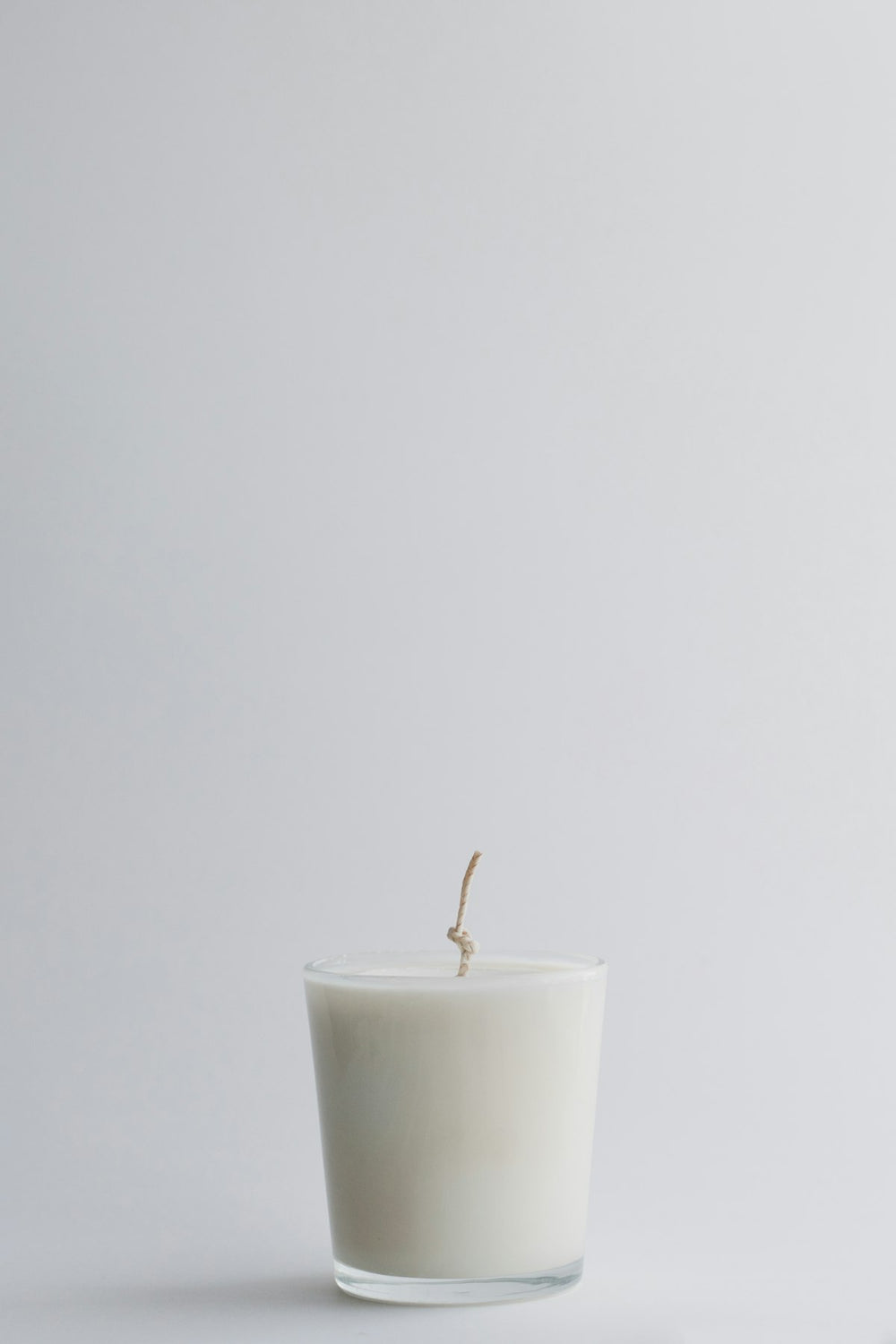 White candle in a glass jar