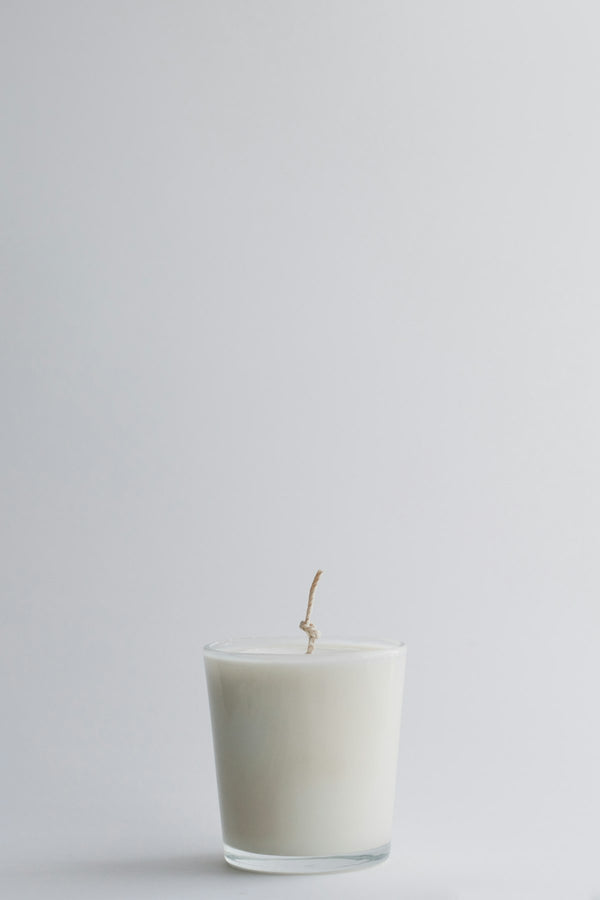 White candle in a glass jar